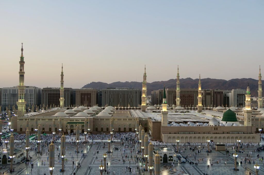 Stunning aerial image of Al-Masjid an-Nabawi in Medina, KSA at dusk, showcasing Islamic architecture.